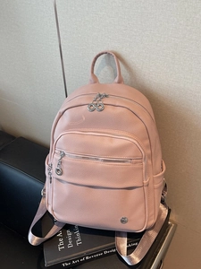 Pink lychee texture faux leather backpack with silver zippers and webbing straps