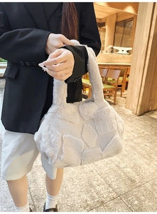 Detail view of plush faux fur tote bag with textured patchwork design in a cafe setting