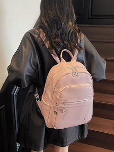 Pink lychee textured faux leather backpack with metallic ring zipper detail and large capacity