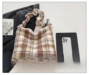 Détail du sac cabas en peluche à carreaux montrant sa grande capacité et sa texture