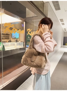 Detail of coffee brown plush tote bag featuring textured 3D heart patterns for winter