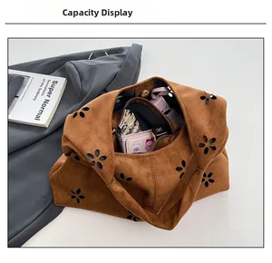 Detail view of the spacious interior of this brown suede hollow-out tote bag capacity