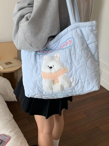Quilted light blue tote bag with heart patterns and lucky puppy plush dog detail