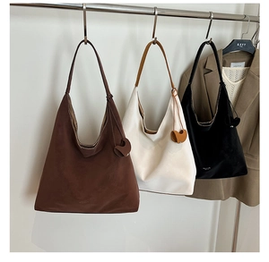 Three minimalist large capacity tote bags in brown, beige and black with heart charms