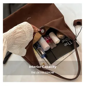 Macro view of large suede tote bag interior showing spacious capacity for tablets and cosmetics