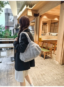 Detail of grey plush tote bag with embossed rose pattern and large capacity design