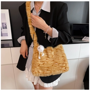Detail of plush faux fur shoulder bag with wavy texture and cute monster charm