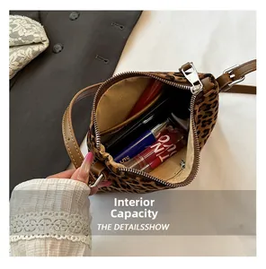 Overhead view showing spacious inner compartment of leopard print bag with makeup