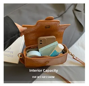 Interior view showing the large capacity of a brown textured vintage crossbody bag
