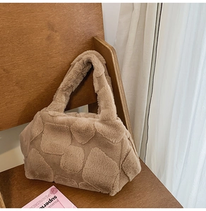 Detailed macro view of khaki faux fur tote bag with 3D embossed square grid pattern texture