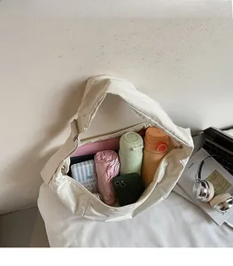 Spacious interior of a cream crossbody bag showing daily essentials and water bottles