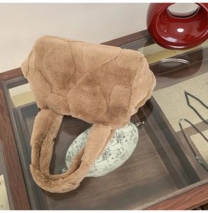 Detail of caramel faux fur tote bag showing heart-shaped quilted pattern and plush texture