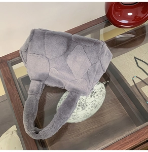 Detail of grey faux fur tote bag showing the textured quilted pattern and soft handles