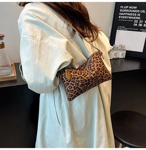 Close-up of leopard print underarm bag with premium leather zipper and strap details