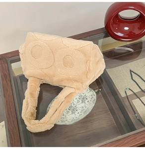 Detailed view of beige plush tote bag with embossed circular patterns and soft faux fur texture