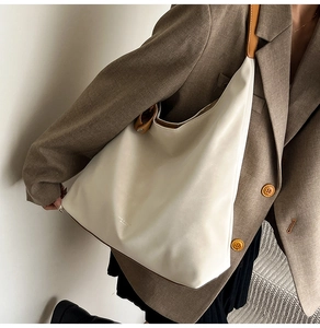 Detail of a large cream leather hobo bag showing its soft texture and slouchy design