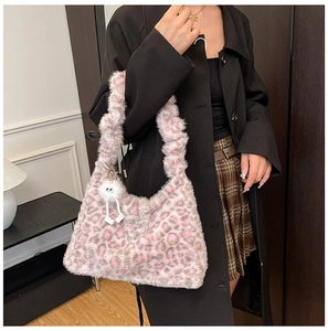 Pink leopard print faux fur shoulder bag with ruched handle and white plush charm