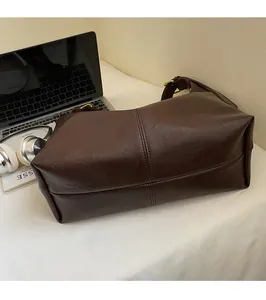 Macro detail of dark brown leather tote bag with vertical stitching for office commuting