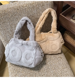 Detailed close-up of fluffy faux fur tote bags with textured 3D circular patterns