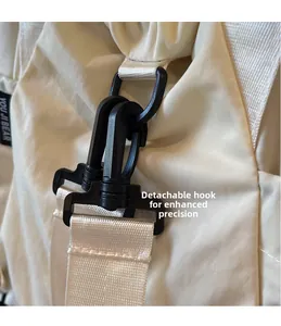 Detail of detachable swivel hook and nylon webbing on beige canvas tote bag