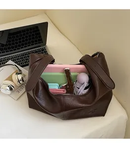 Detail view of large capacity tote bag interior storing tablet umbrella and wallet