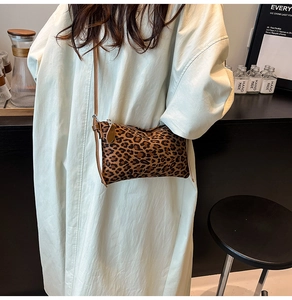 Detailed view of the leopard print crossbody bag with a slim leather shoulder strap