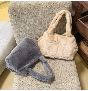 Detail of plush faux fur tote bags with geometric diamond and circular embossed patterns