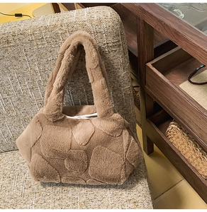 Detail of plush brown faux fur tote bag with geometric texture on a cozy chair