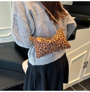Close-up of leopard print shoulder bag featuring textured faux fur and leather strap