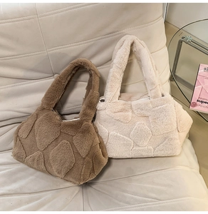 Close-up of brown and cream faux fur tote bags with geometric quilted texture on sofa