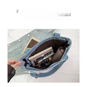 Internal view of blue canvas tote bag showing large capacity and organized compartments