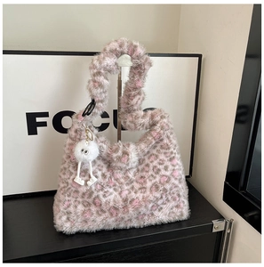 Close-up of pink leopard faux fur tote bag with a whimsical white plush leg doll charm