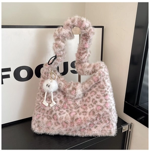 Detail of soft faux fur texture on pink leopard print shoulder bag with plush charm