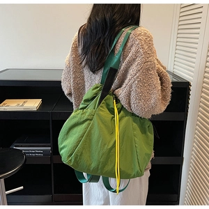 Detail of green canvas tote bag with yellow drawstring and durable wide shoulder straps