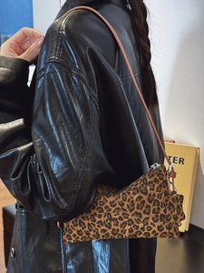 Stylish leopard print underarm bag with slim brown strap and sleek zipper closure