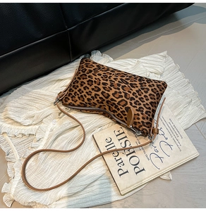 Detailed view of leopard print crossbody bag with sleek zipper and brown shoulder strap
