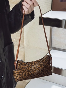 Leopard print crossbody bag with sleek brown leather strap and silver zipper closure