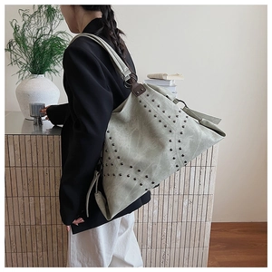 Oversized hobo bag in washed faux leather featuring vintage rivets and slouchy silhouette