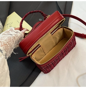 Detail view of red tweed crossbody bag interior with zip pocket and card slot