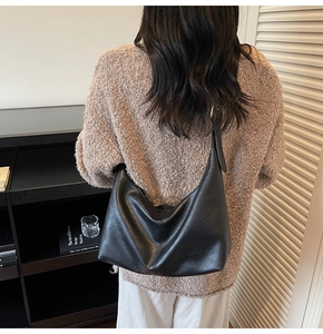 Detail view of large black leather hobo bag showing soft texture and spacious design