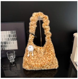 Close-up of leopard print faux fur tote bag with a cute white plush ball keychain charm