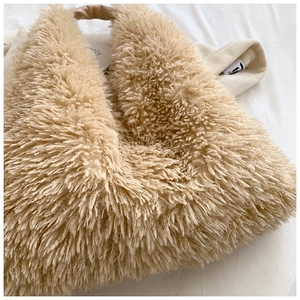 Close-up of fluffy beige faux fur tote bag showing soft texture and premium plush material