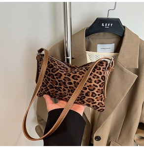 Detail of leopard print shoulder bag with suede texture and silver zipper closure