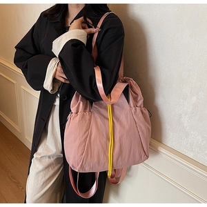 Detail of pink canvas tote bag showing large capacity and yellow drawstring closure