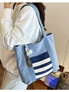 Light blue canvas tote bag for women with striped pocket and plush ball charm