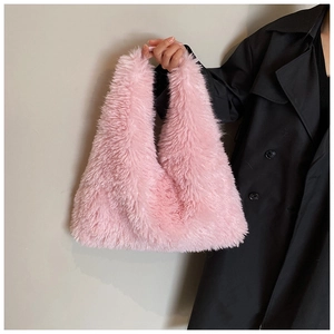 Detailed close-up of soft pink faux fur material on this stylish tote bag handle