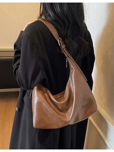 Vintage brown leather hobo bag with adjustable wide shoulder strap and matte finish