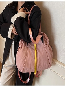 Pink canvas drawstring tote bag for women with contrasting yellow cords and wide strap
