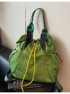 Olive green versatile nylon drawstring tote bag with yellow cords for outdoor style