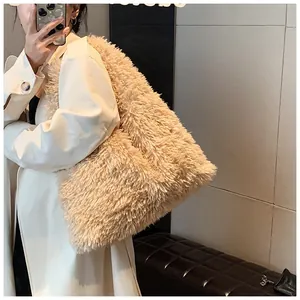 Mirror selfie showing a large plush faux fur tote bag in beige with fluffy texture